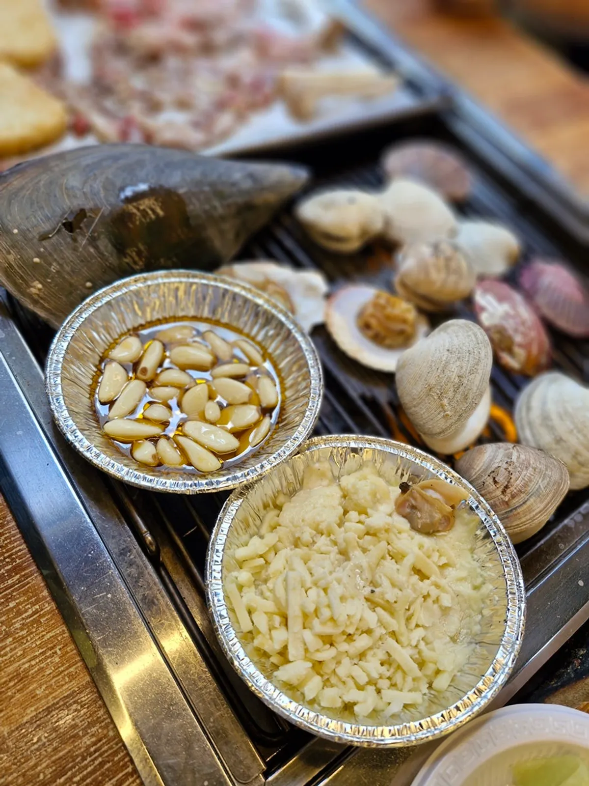 Geoduck, scallops and clams with cheese on the grill