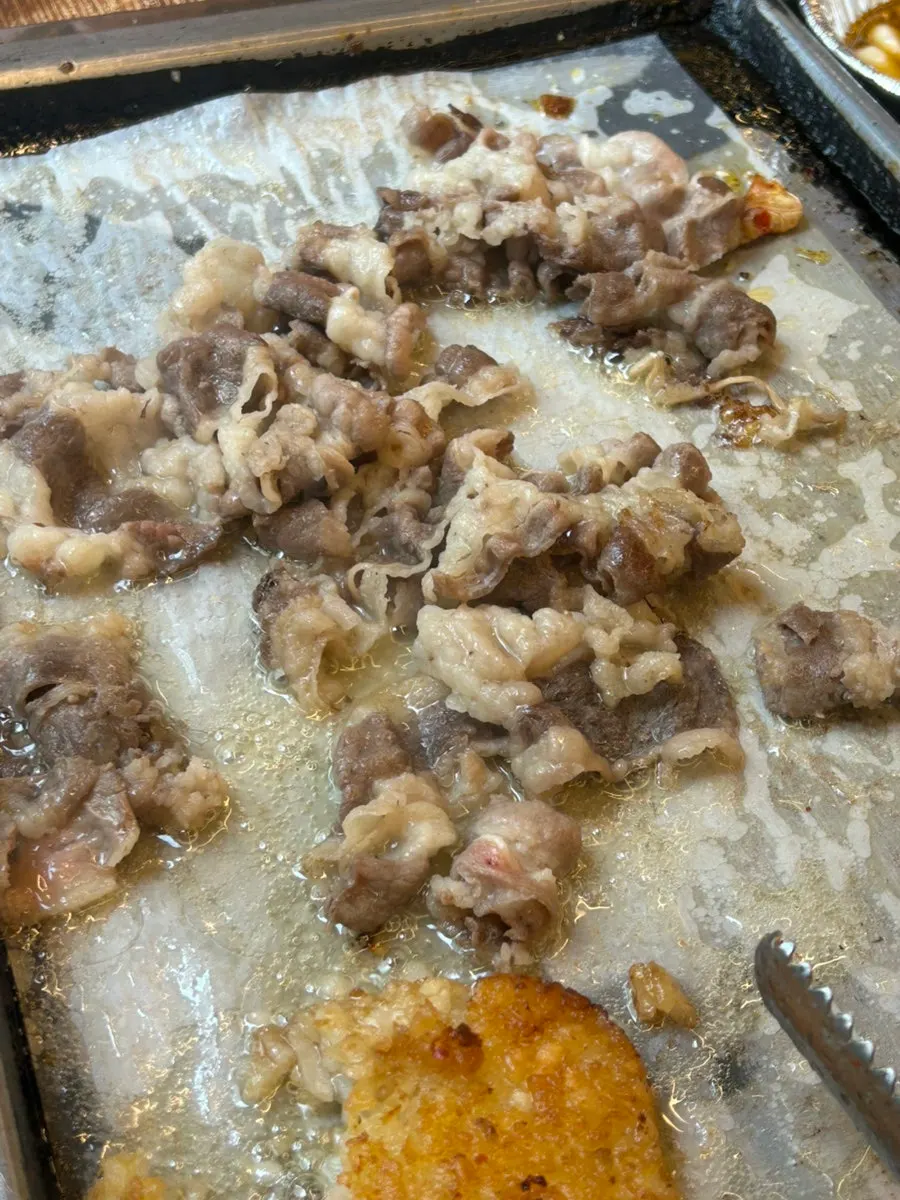 Beef brisket and hash browns grilling