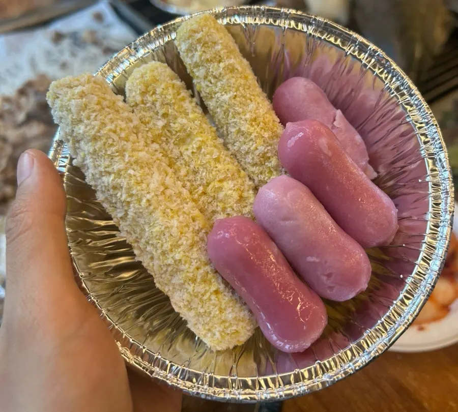 Cheese sticks and rice cake placed on the grill