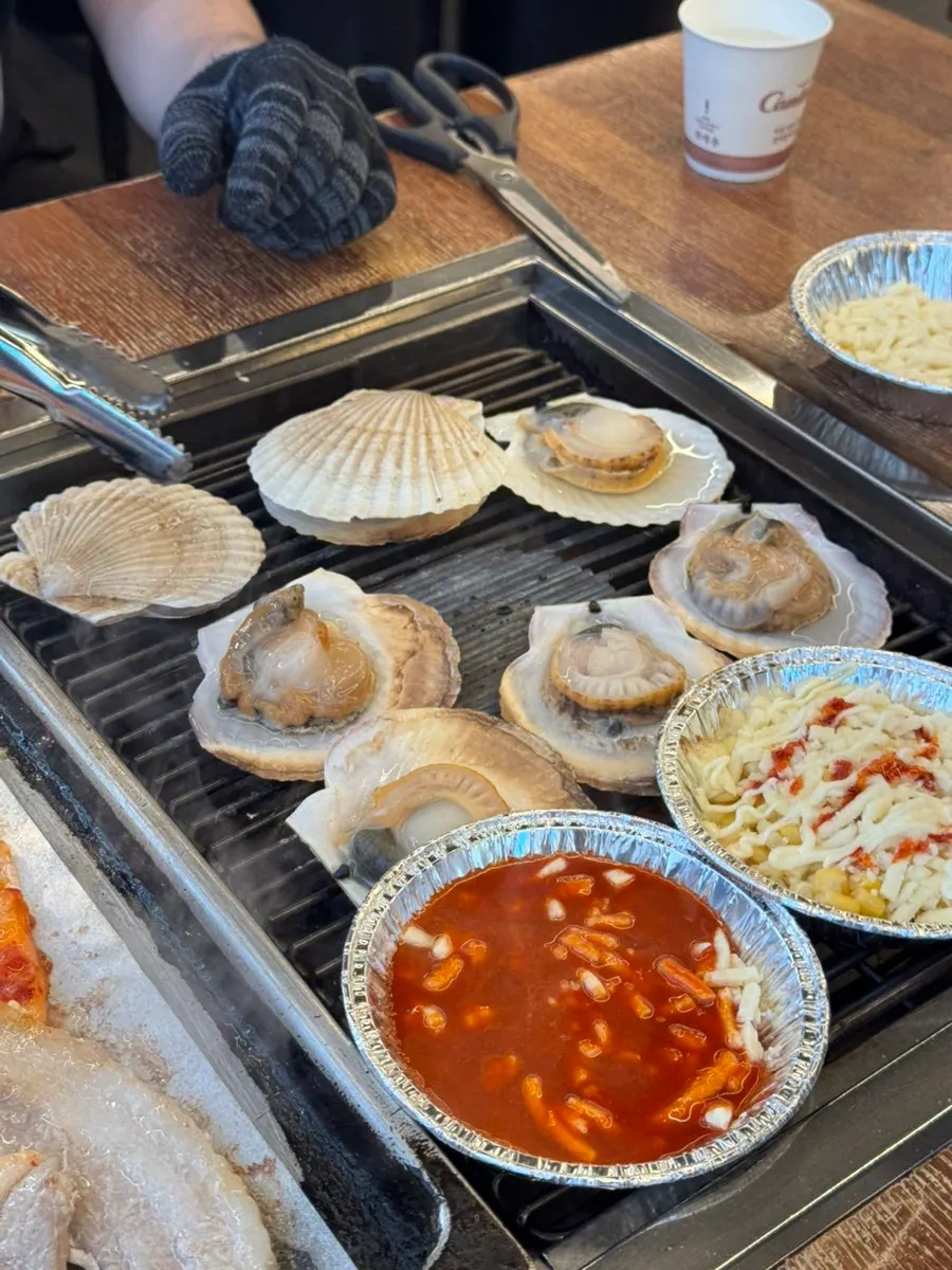 Plancha con carne en un lado y marisco en el otro