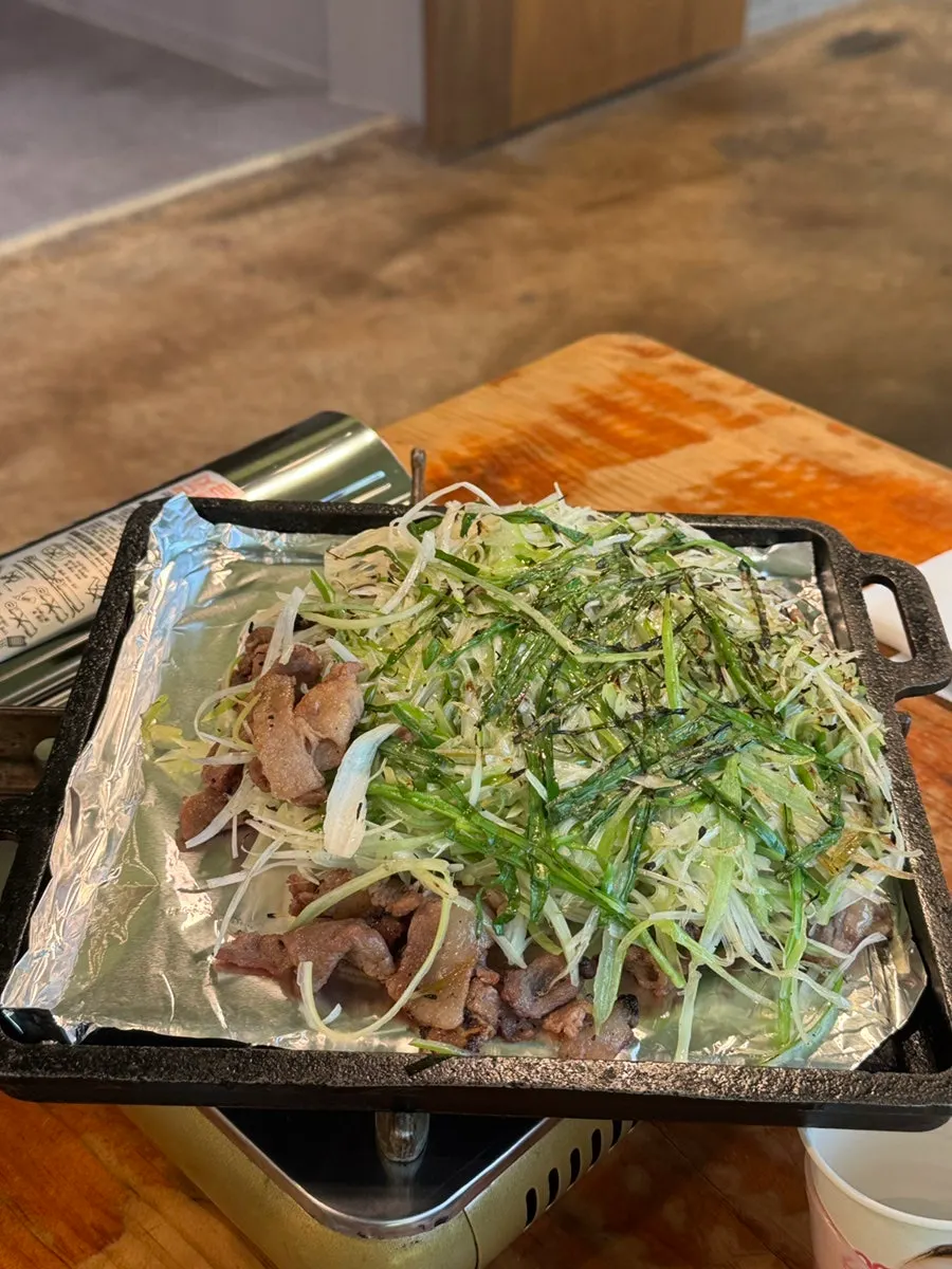A piece of charcoal bulgogi eaten with scallions