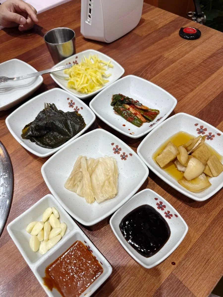 Table setting with green onion kimchi and white kimchi