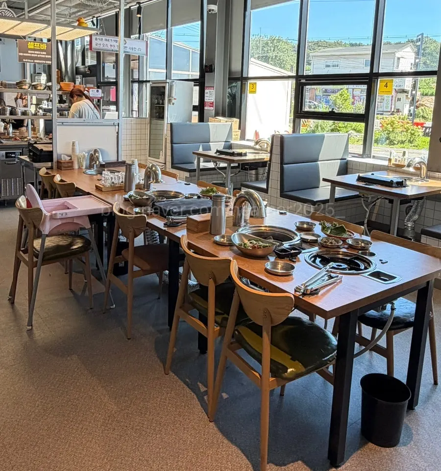 Seating by the large windows inside Grill Duck