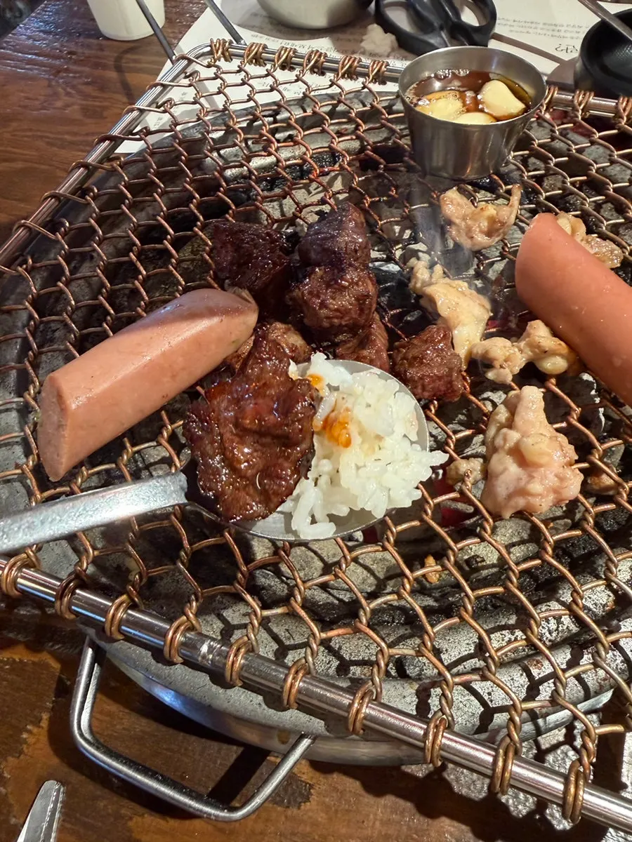 Marinated beef ribs grilling over charcoal