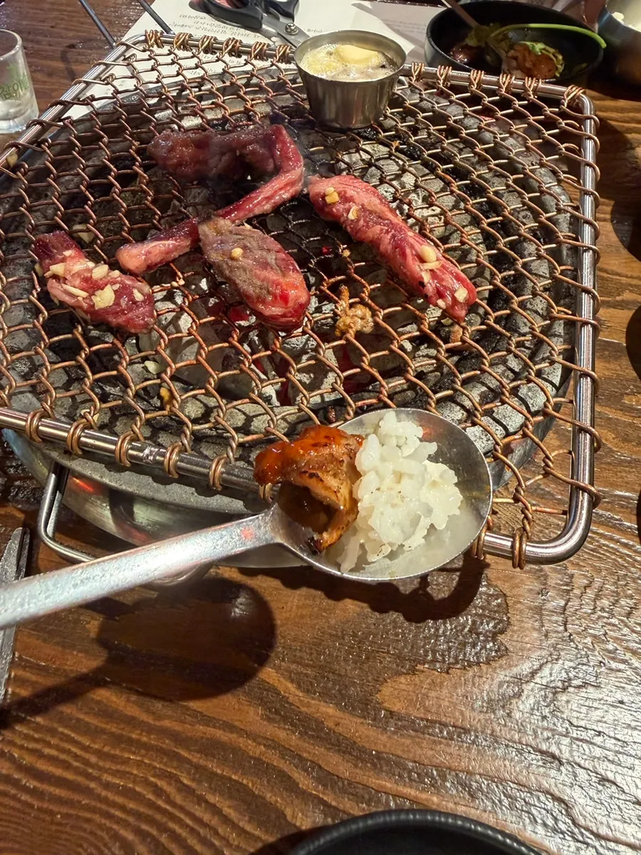 Meat cooking over charcoal