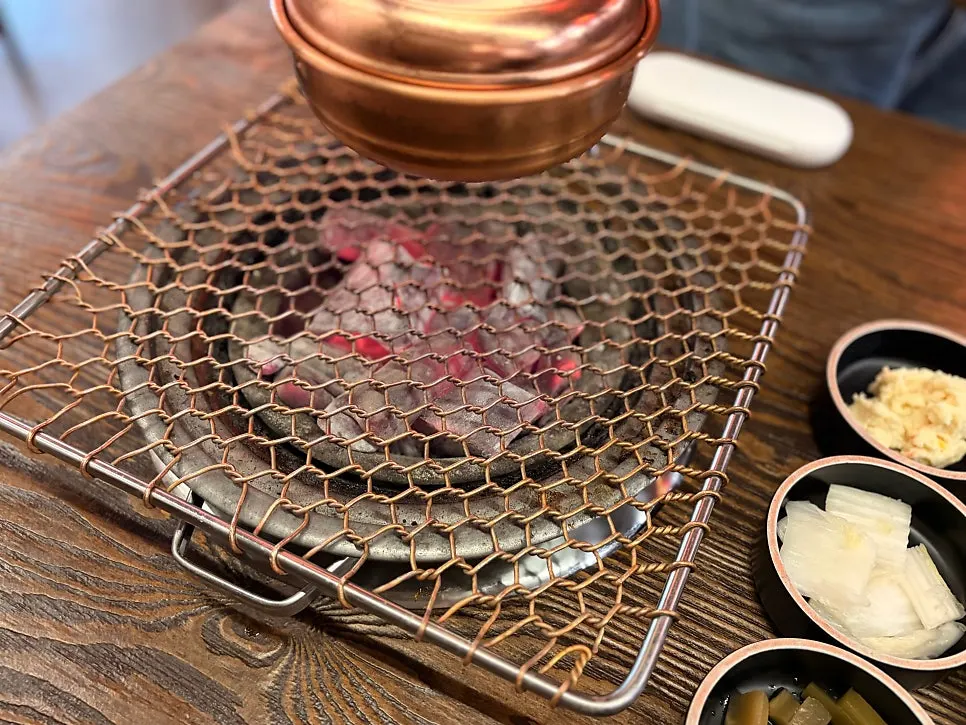 Gyeongju-style marinated beef short ribs grilling on the grate