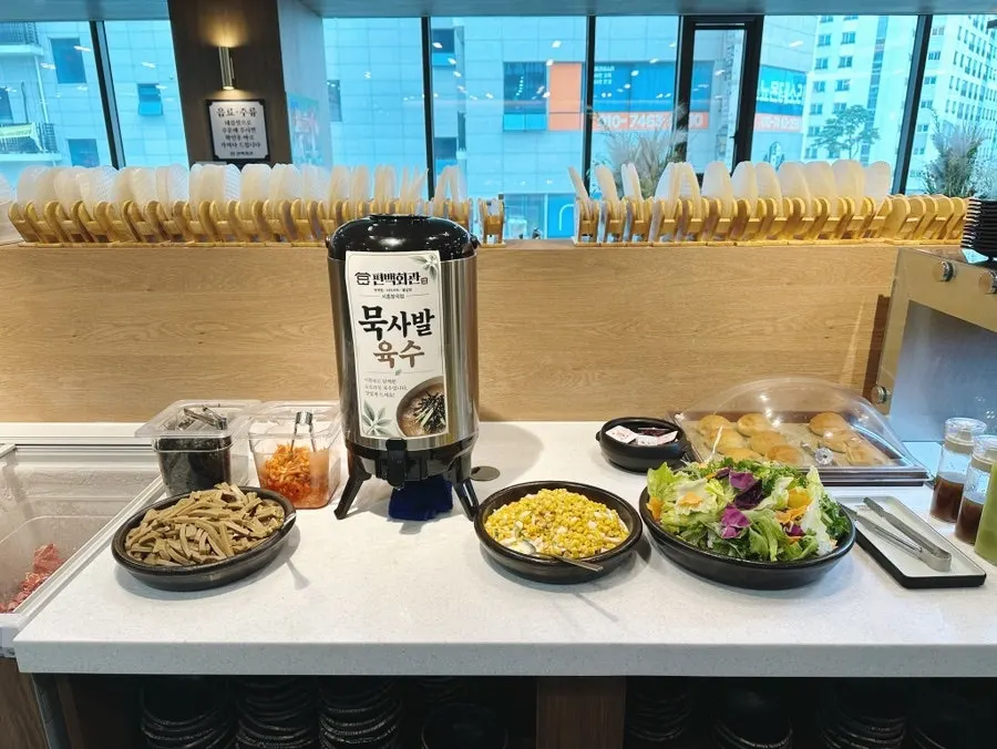Buffet dishes including japchae and muksabal