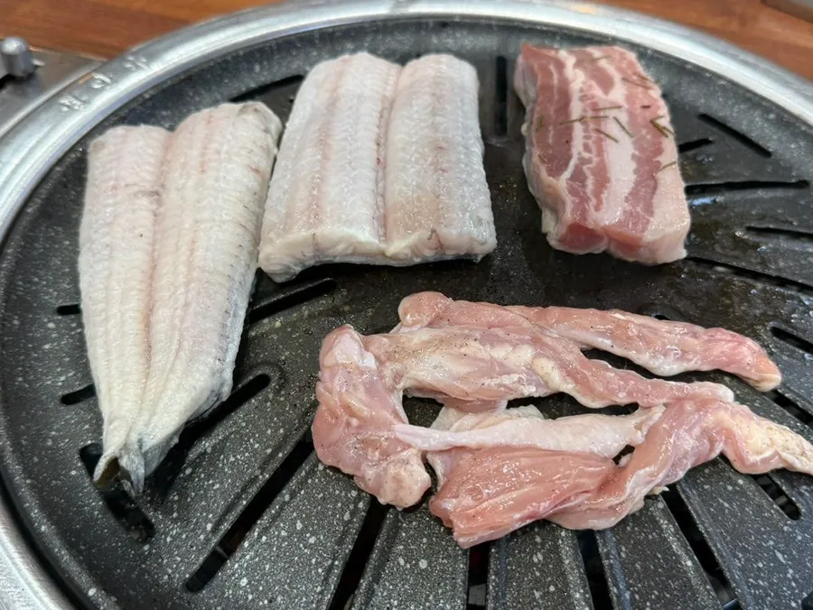 Freshwater eel, pork belly, and chicken neck on the grill
