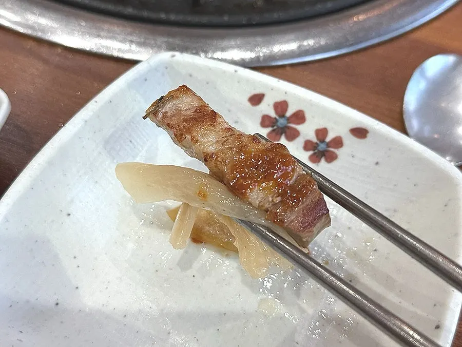 Pork belly and chicken neck grilling alongside the eel
