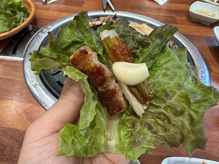 The tail portion of the eel being grilled