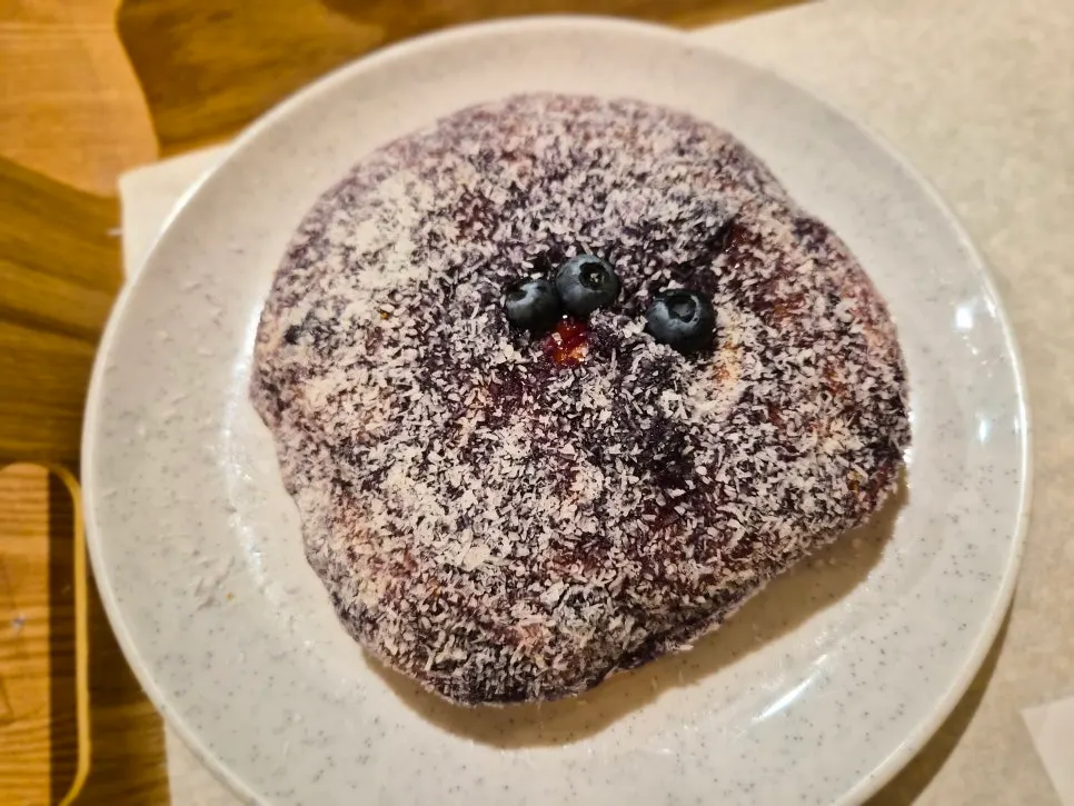 Blueberry cream cheese bread sprinkled with coconut flakes