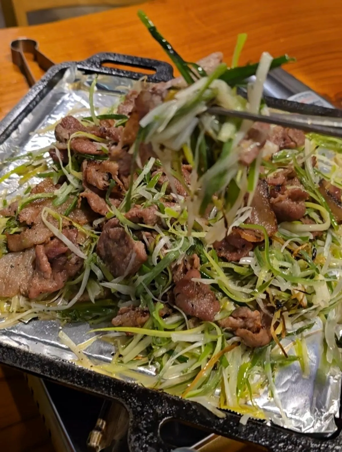 Scallion bulgogi piled high on the grill