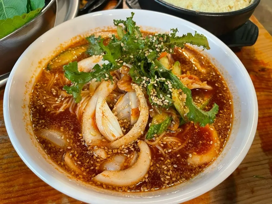 Mom's hand egg custard and bibim noodles served in a large stone pot