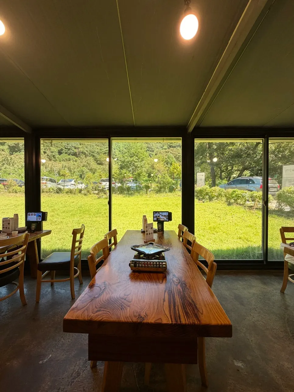 Seating inside Bulhyangjip with a mountain view through the window wall