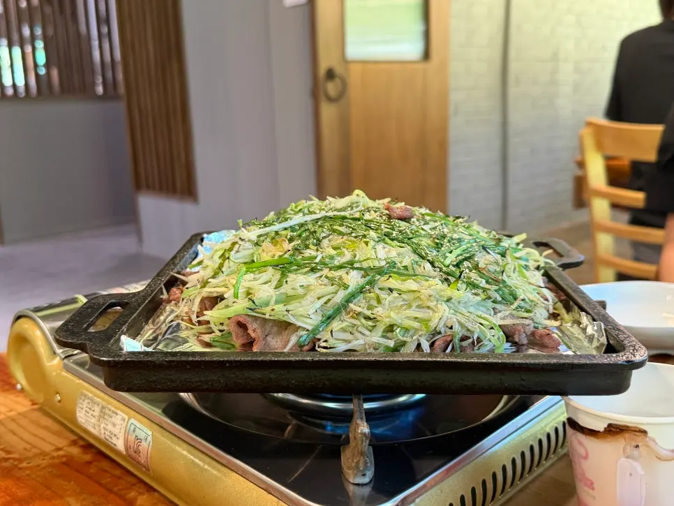 Charcoal scallion bulgogi served in a large metal bowl