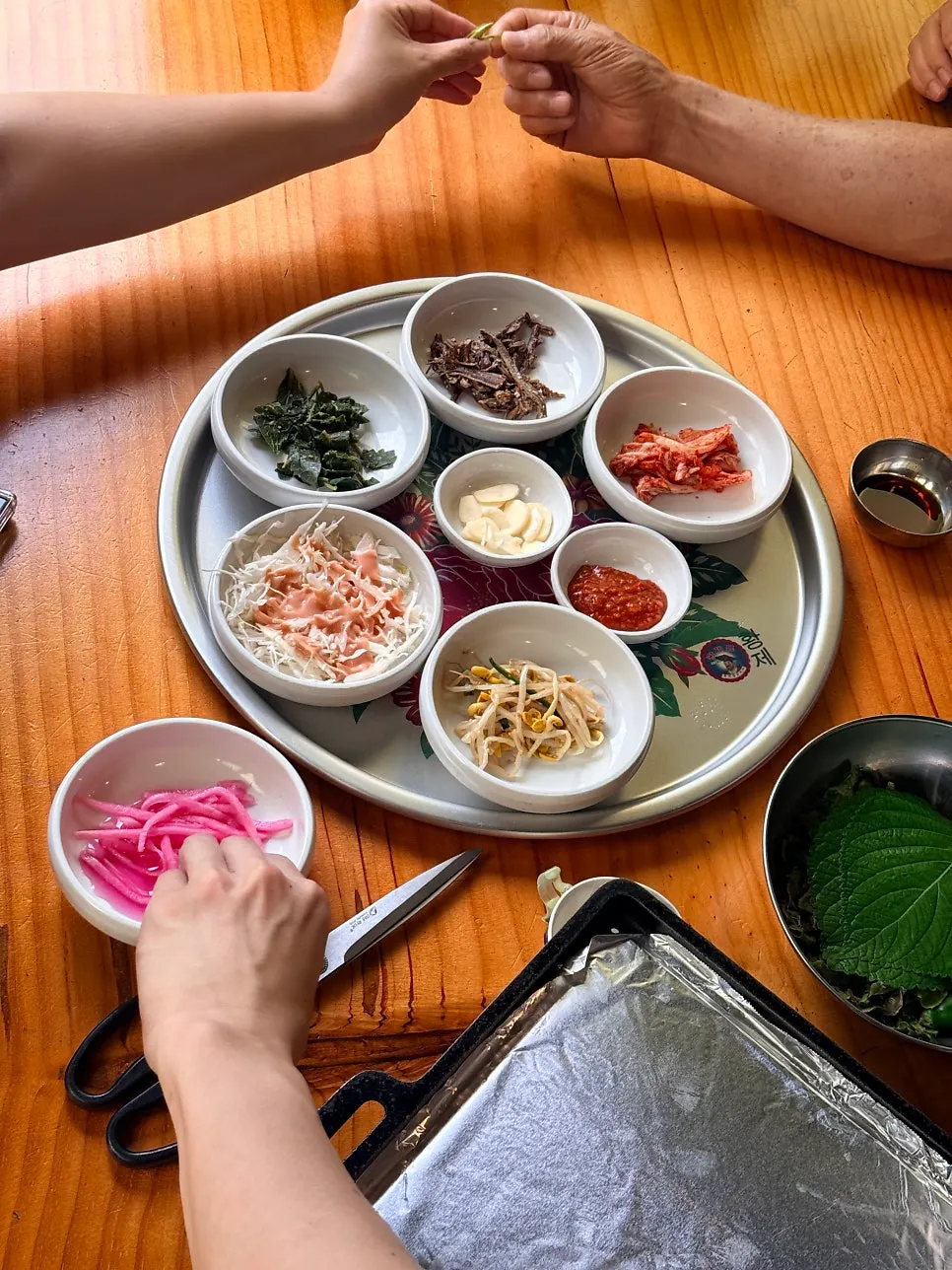 Table setting with chwinamul, gosari, and kongnamul side dishes