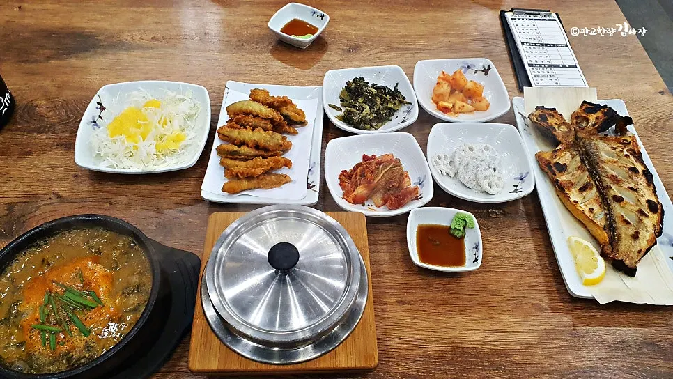 Table set with chueotang, grilled tilefish and fried loach