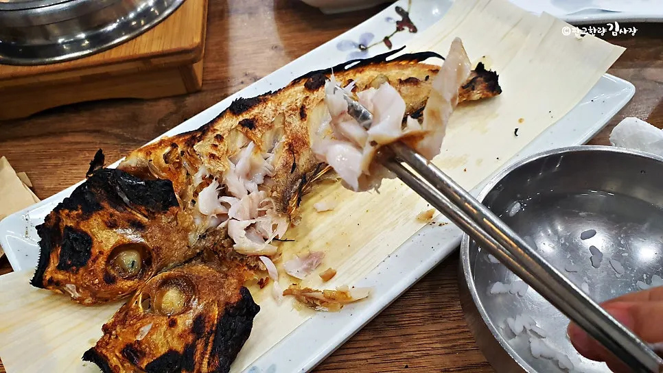 Plate of grilled tilefish after the flesh has been picked apart