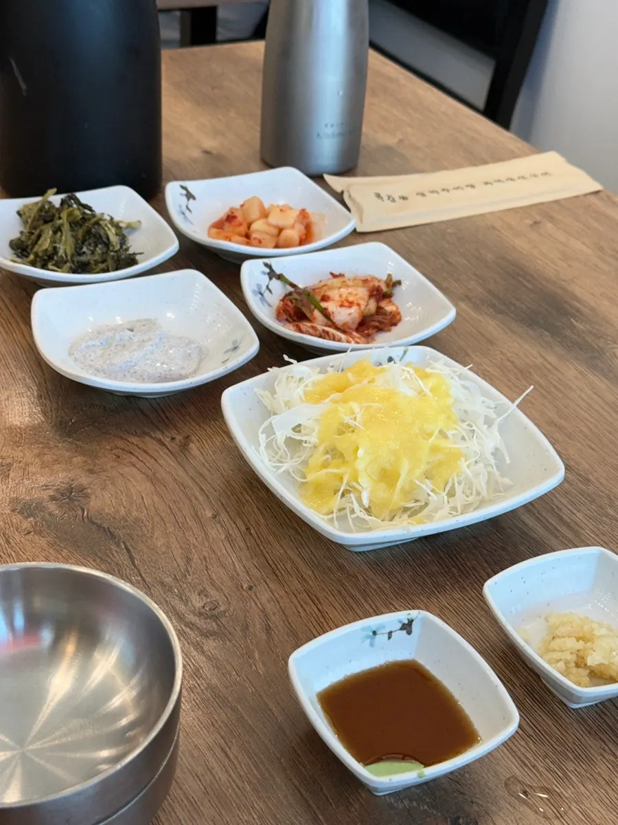 Self-serve side dish bar with aprons hanging beside it