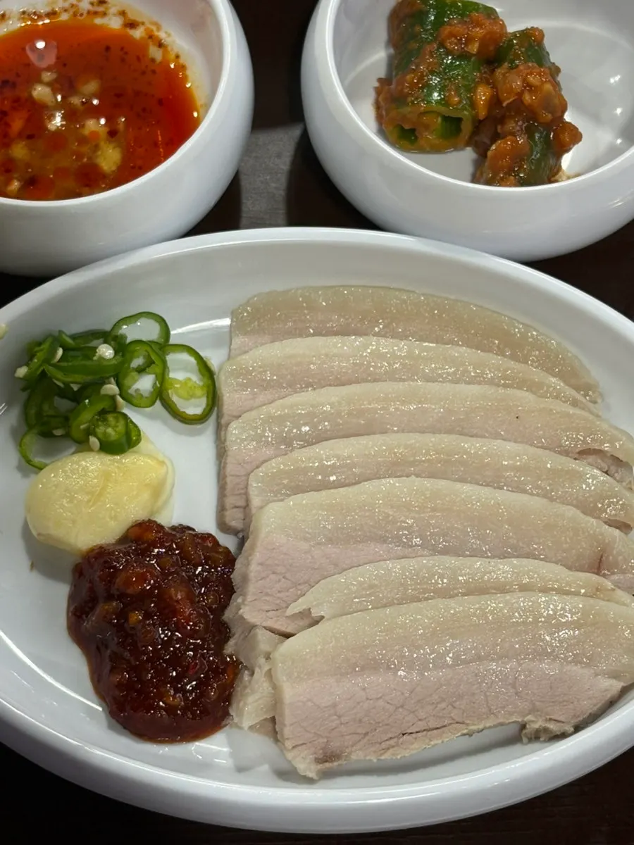 Suyuk plated with kimchi and spicy chili kimchi on the side