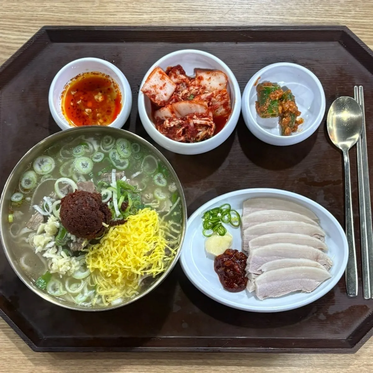 Full spread of the pork jowl suyuk and spicy bone kalguksu set