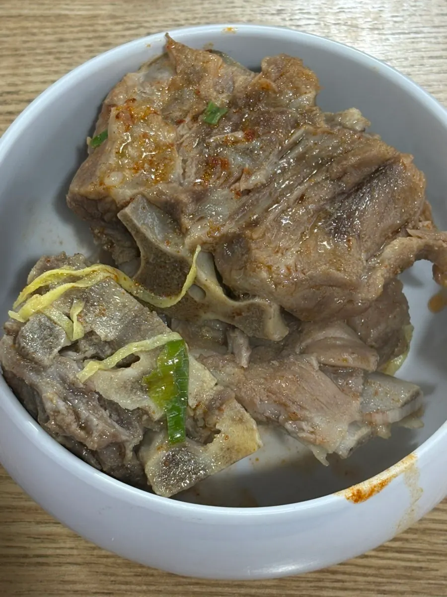 Chewy noodles lifted up with chopsticks