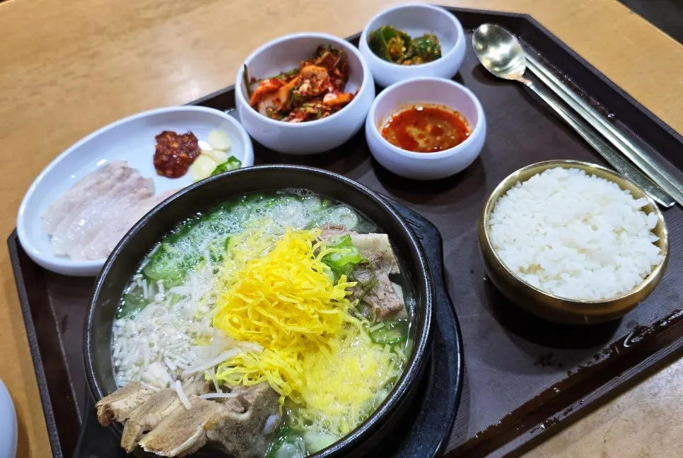 Side dishes of fresh kimchi and cucumber pepper salad