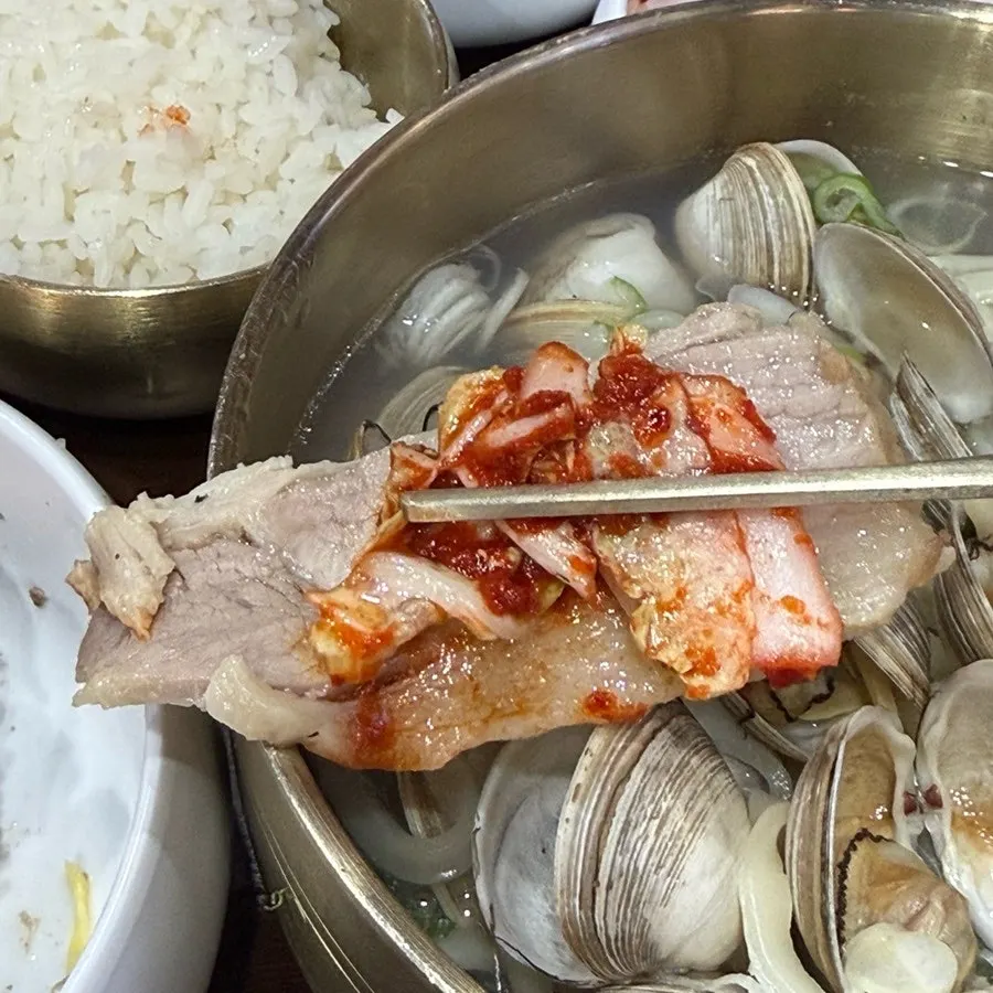 Suyuk topped with fresh kimchi salad