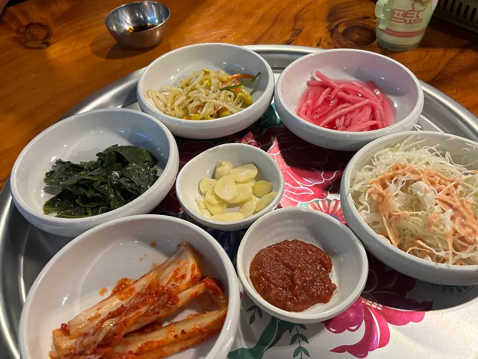 Charcoal bulgogi with a table of basic side dishes