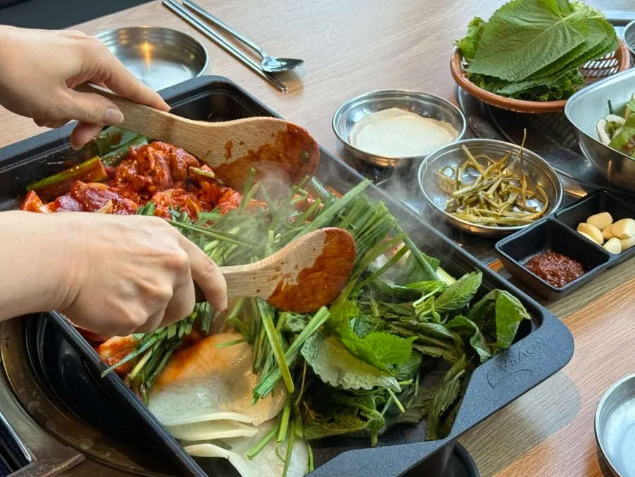 Sweet-and-spicy duck cooking on the grill