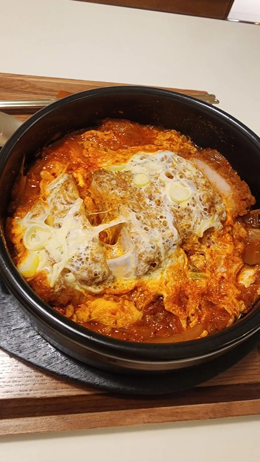 Kimchi nabe earthenware pot topped with cheese and scallions