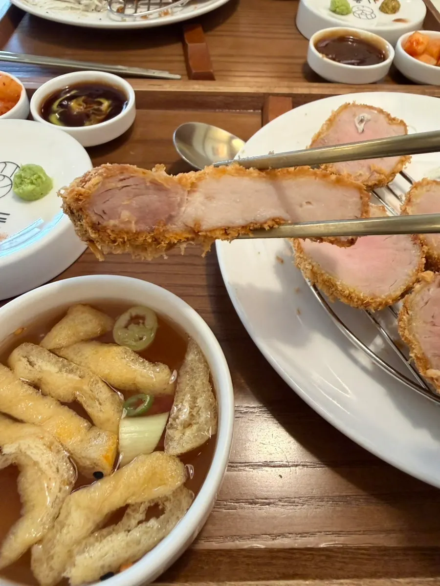 A piece of premium sirloin katsu picked up with chopsticks