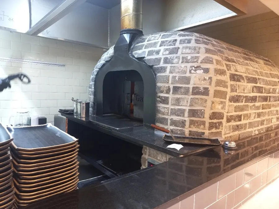 Wood-fired oven grilling fish