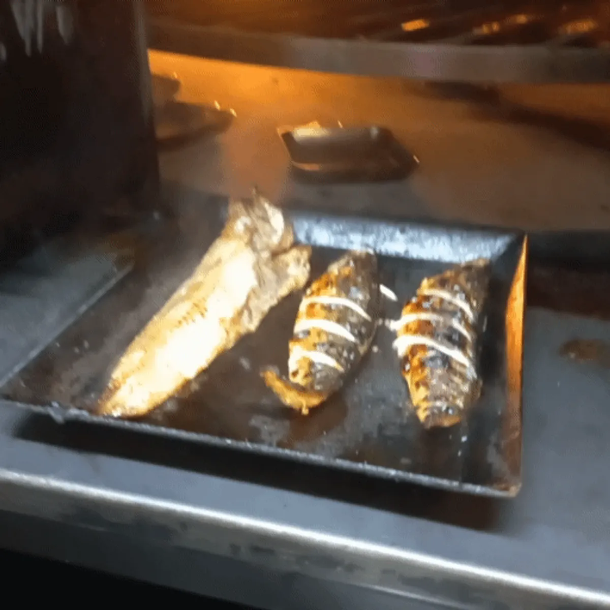 Fish-grilling area in front of the wood-fired oven