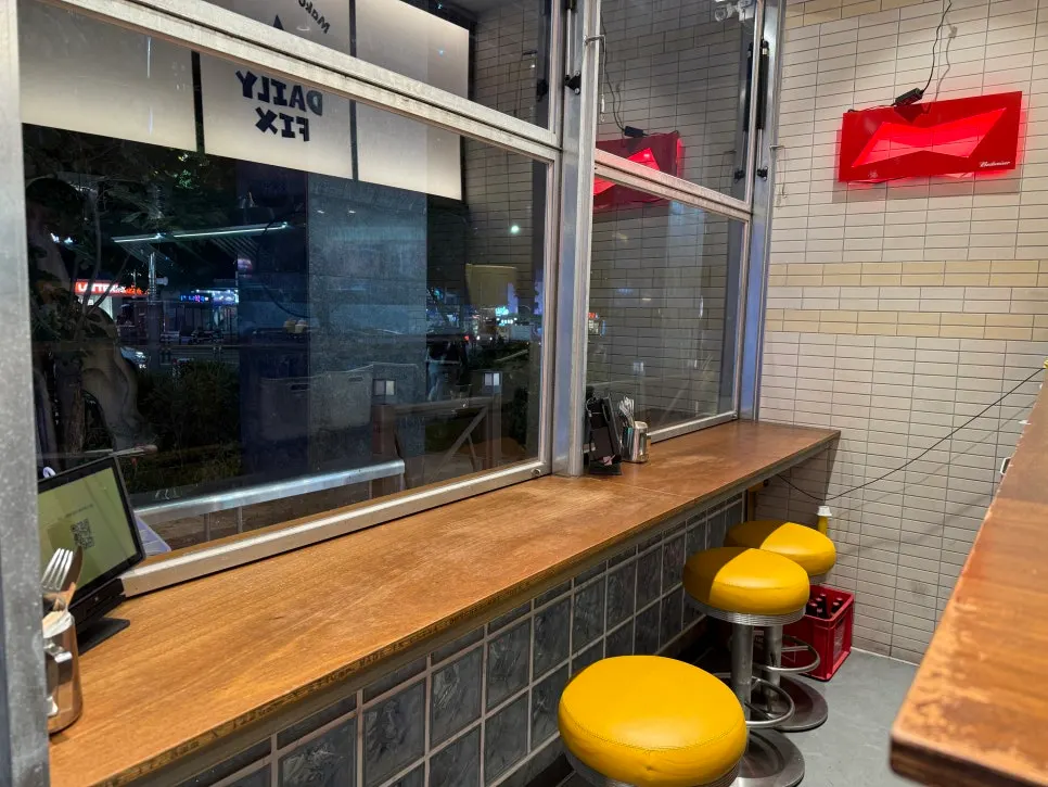 Counter seats beside floor-to-ceiling windows