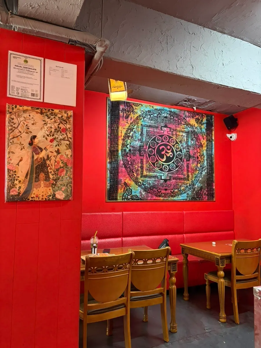 India Darbar dining hall with red walls and wood interior