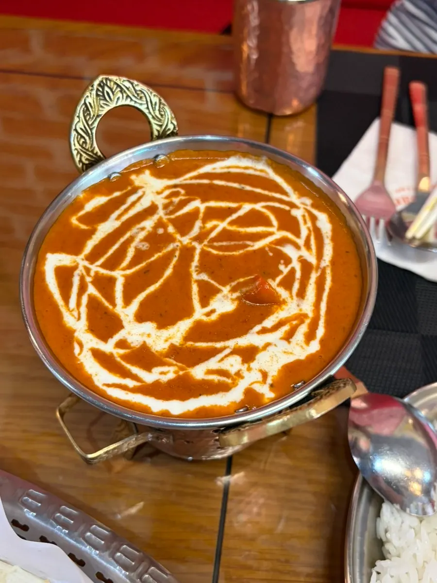 Butter chicken curry with naan and rice