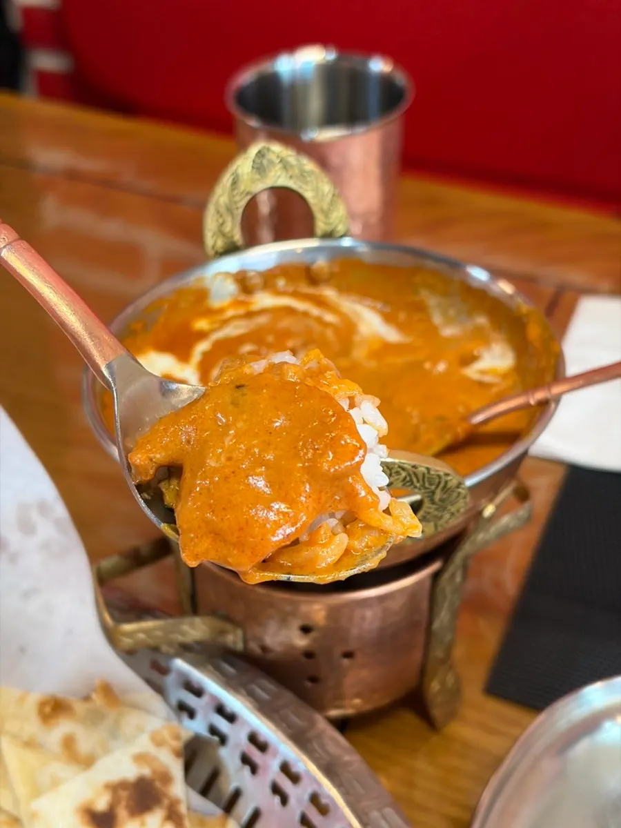 Rice mixed with butter chicken curry