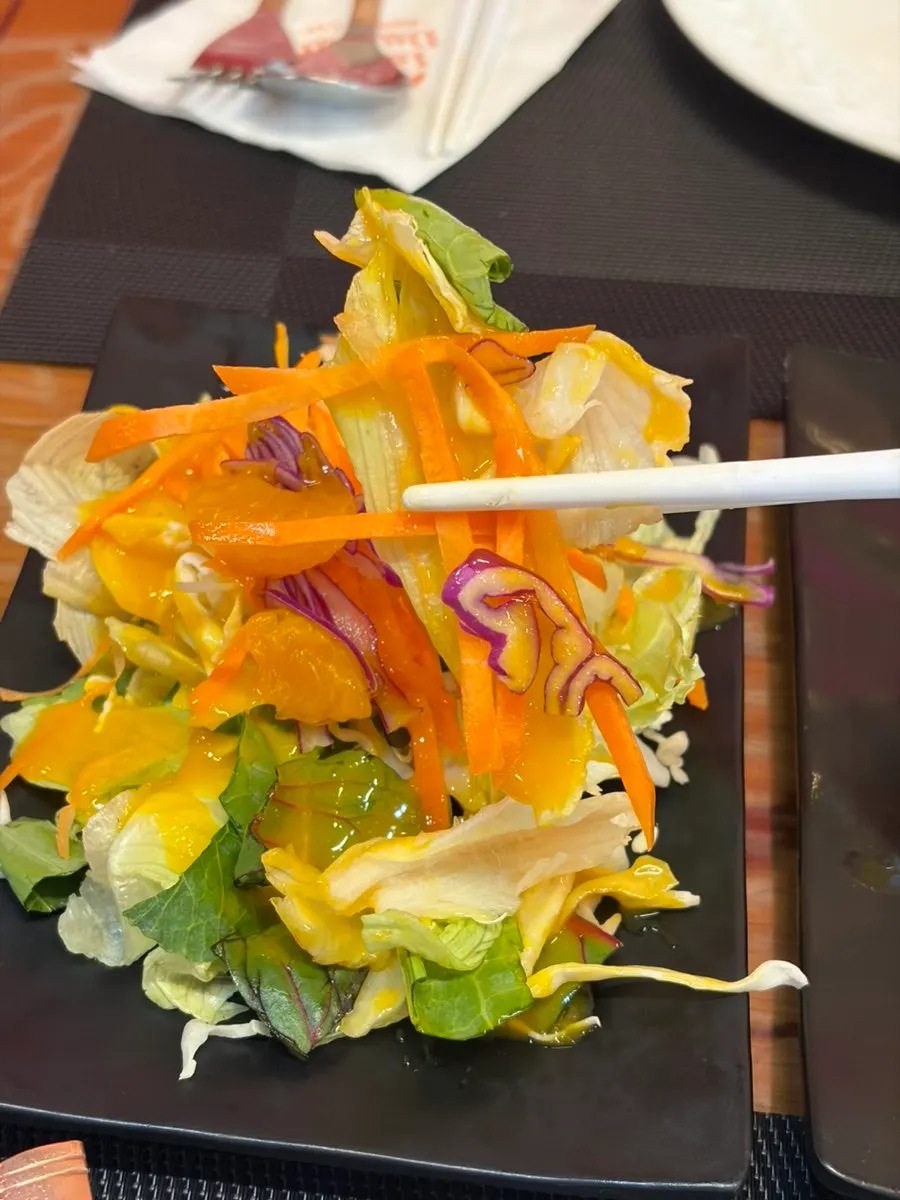 Green salad with dressing on top