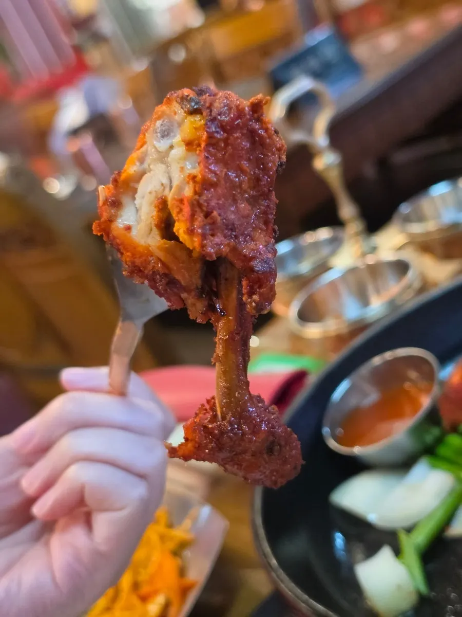 Cross-section of a piece of tandoori chicken picked up
