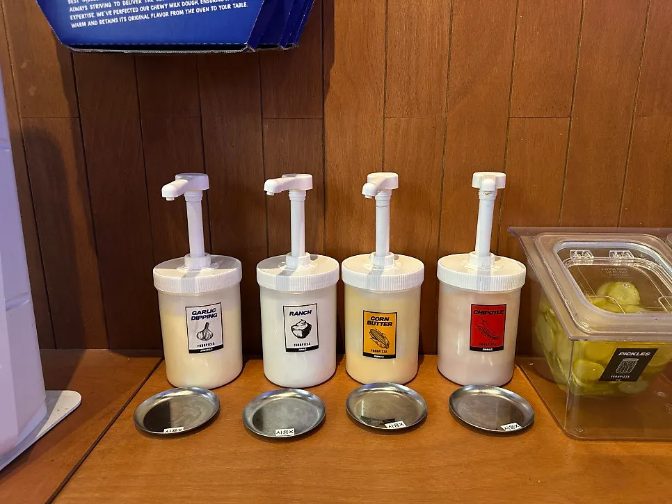 Self-service bar with tableware and sauces