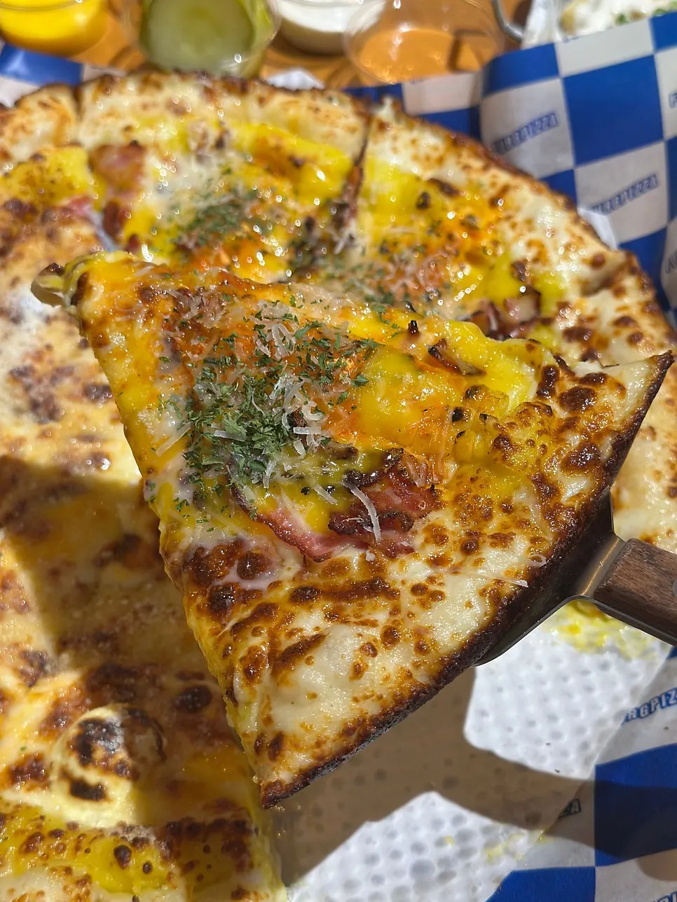 Pizza topped with corn and bacon