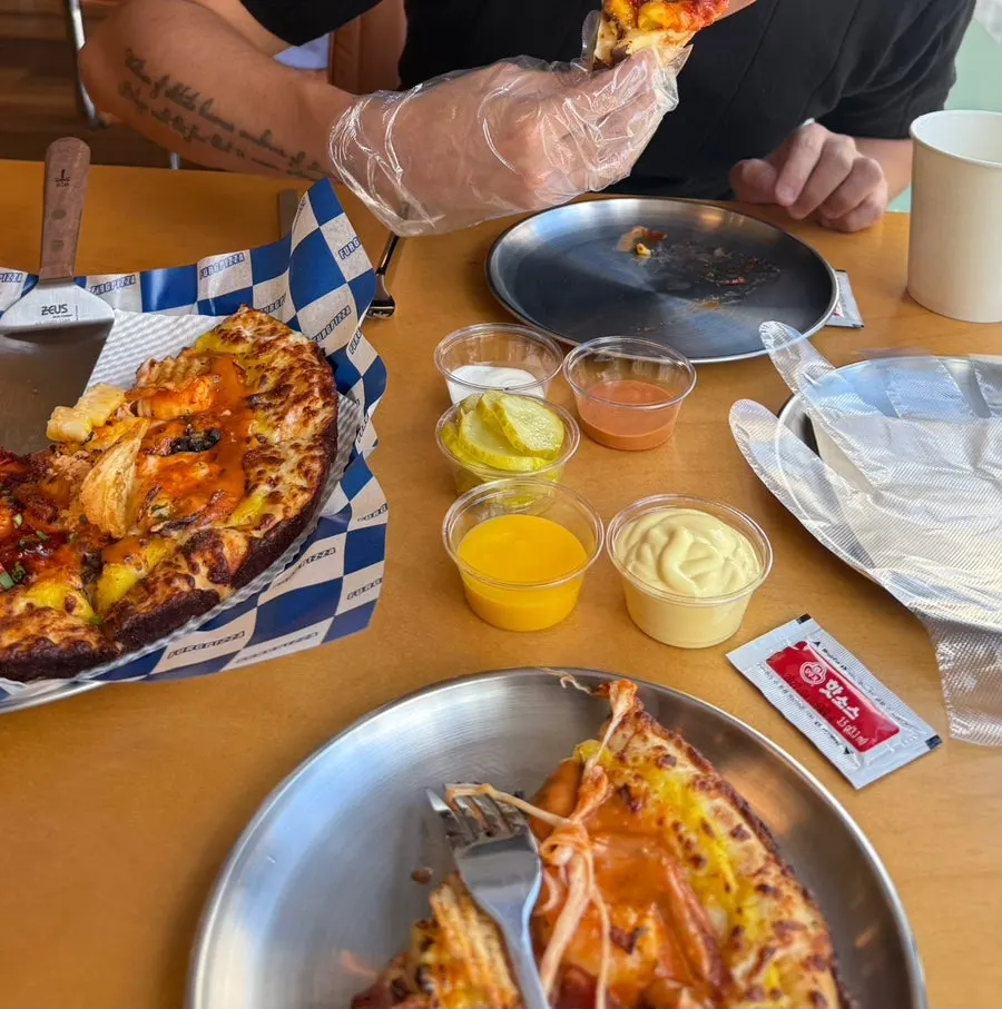Pizza eaten with plastic gloves
