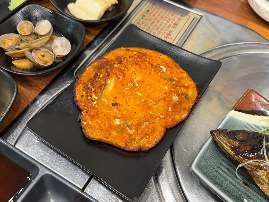 Grilled herring topped with scallions