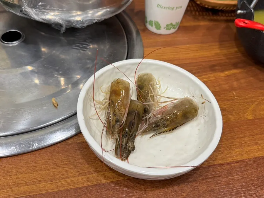Sample raw shrimp sashimi wrapped in plastic wrap