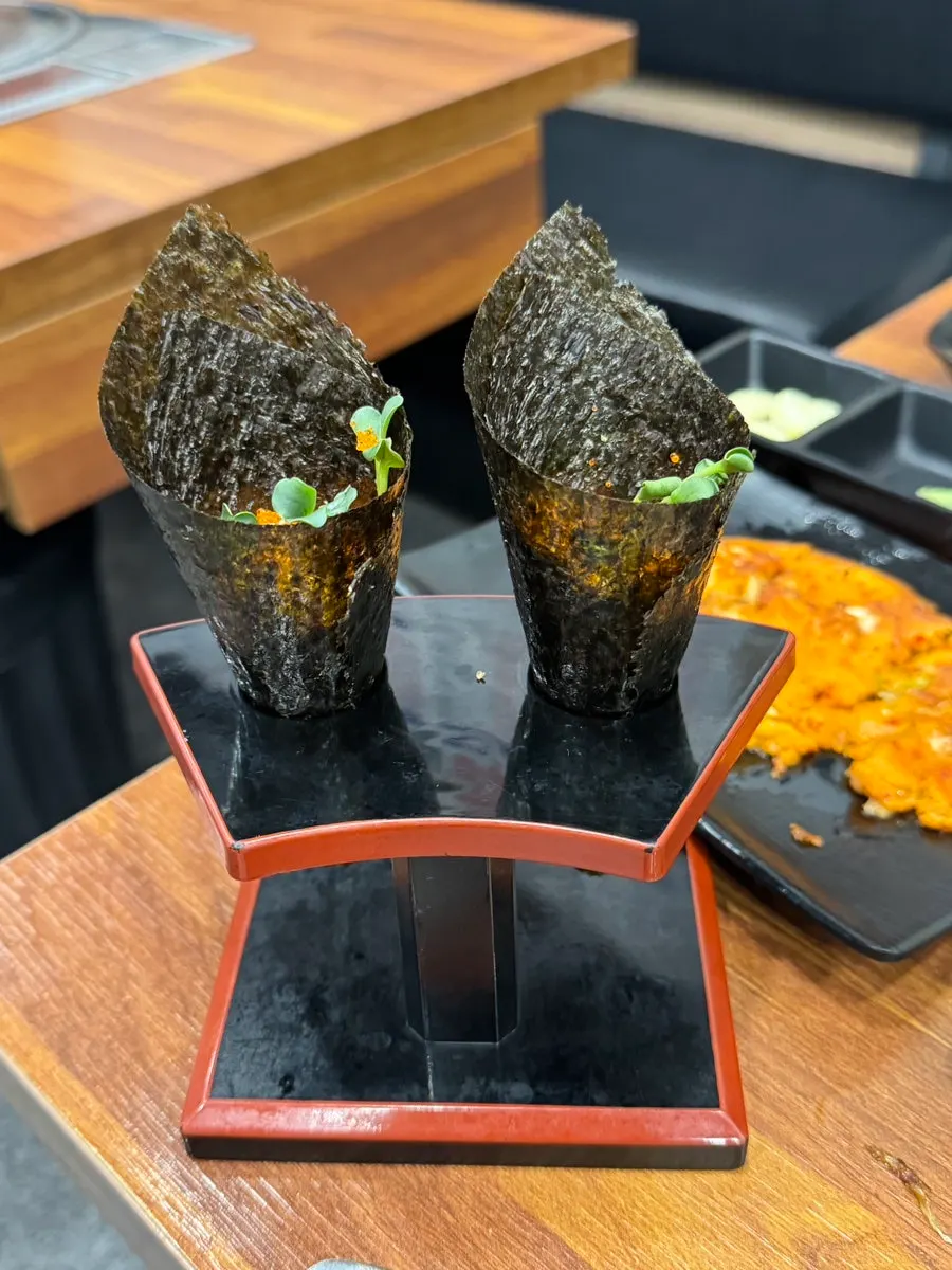 Sashimi and aged kimchi wrapped in a perilla leaf