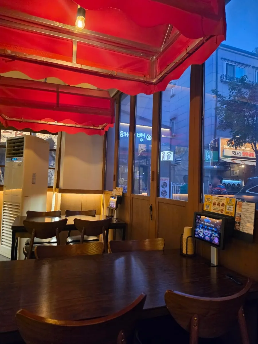 Regular table seating by large windows inside the store