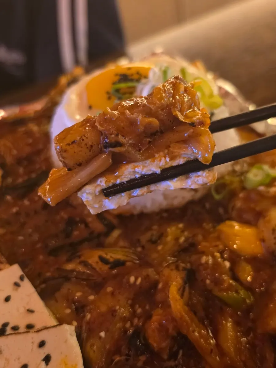 One-bite combo of tofu topped with kimchi and meat