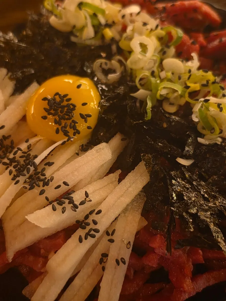 Plate of yukhoe classic topped with egg yolk