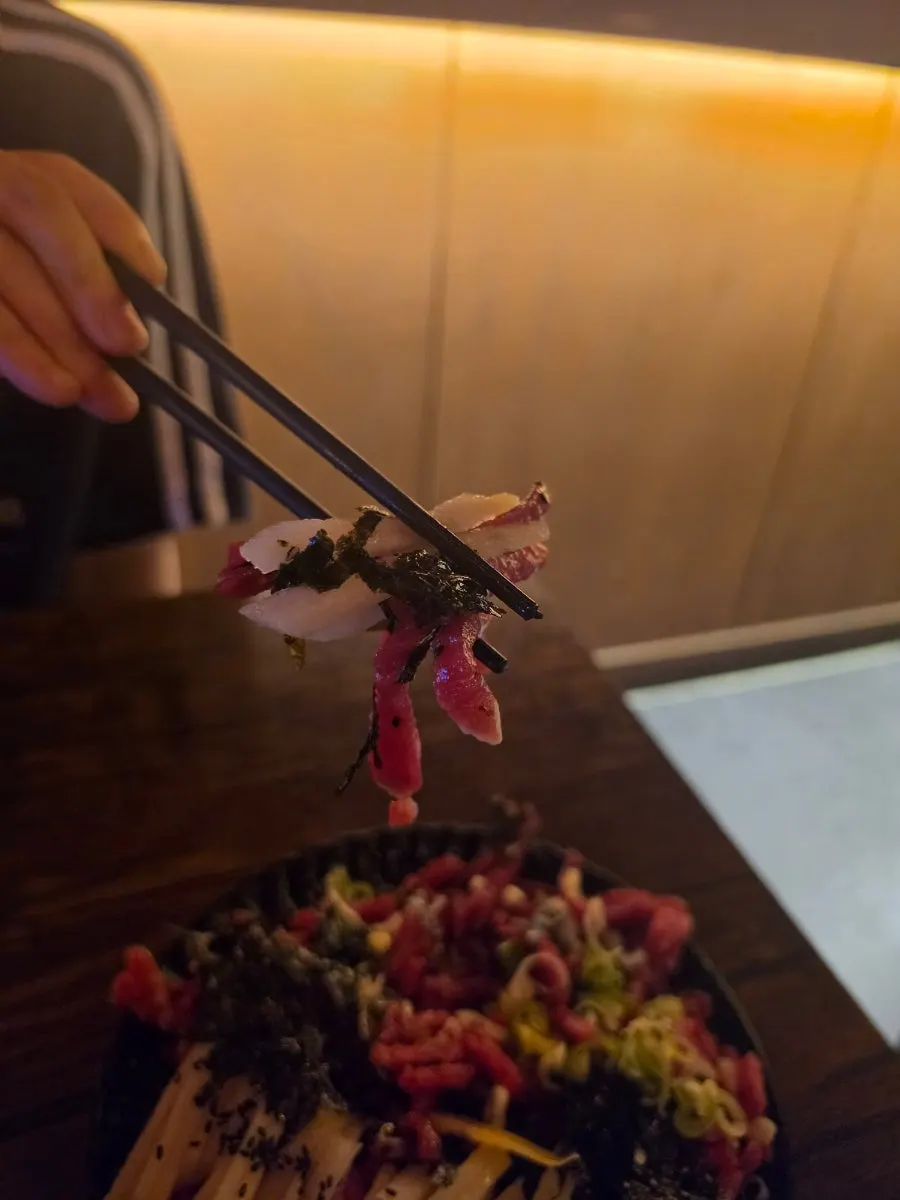 Yukhoe mixed with egg yolk and pear garnish